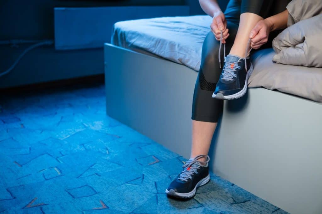 woman-putting-on-running-shoes-right-out-of-bed
