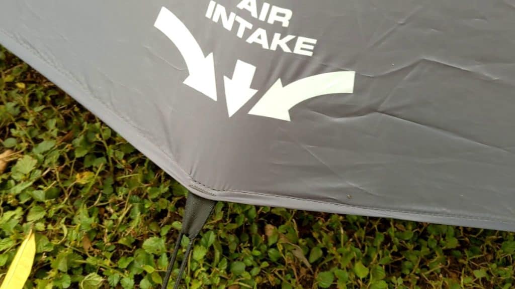 Air intake with a bungee on the bottom stretching out the tent fabric to allow for air to get in