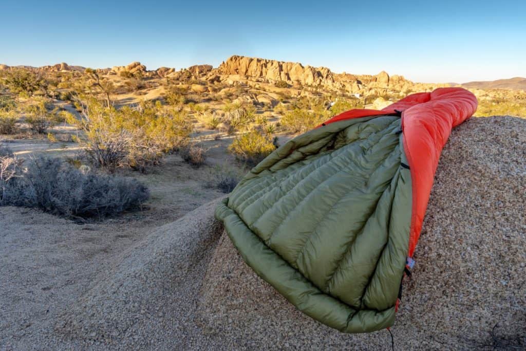 camping quilt splaid out on a rock