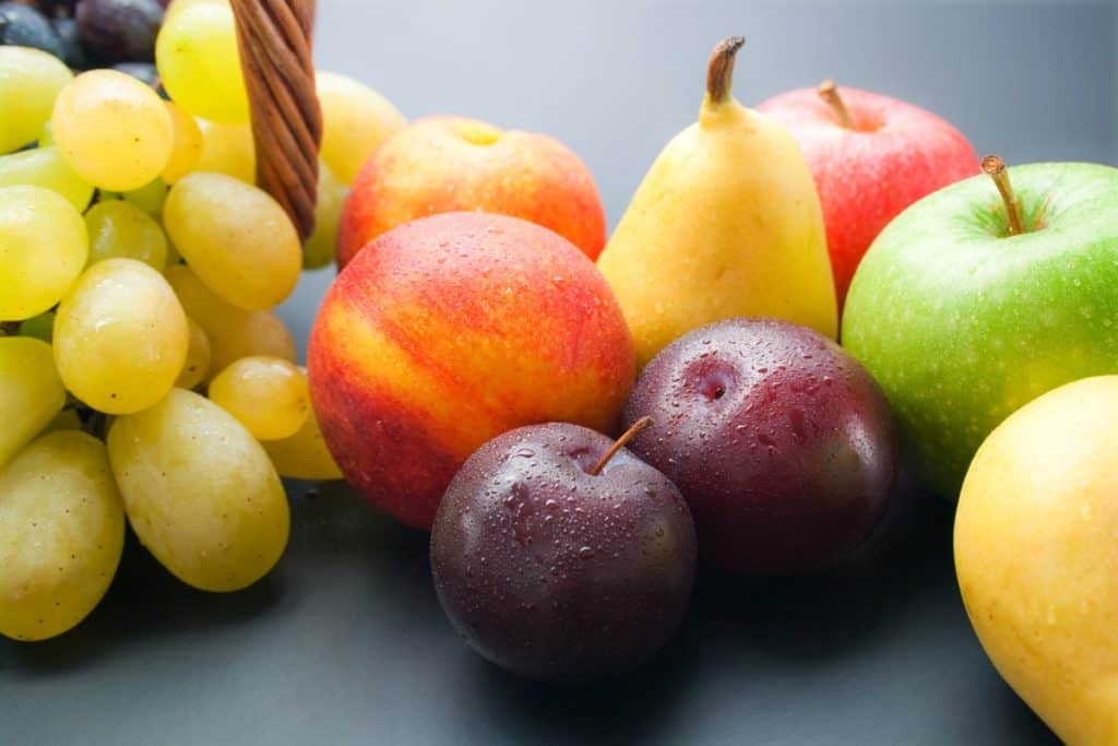 Pile of fruit, plums, pears, grapes, peaches, apples